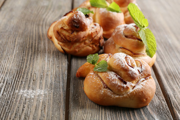 Tasty buns with berries on table close-up