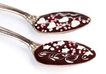 Spoons with tasty chocolate for party. Isolated on white