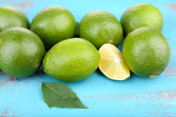 Fresh juicy limes on old wooden table