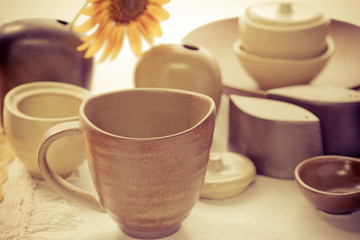 Mug and ceramic bowl on wooden table