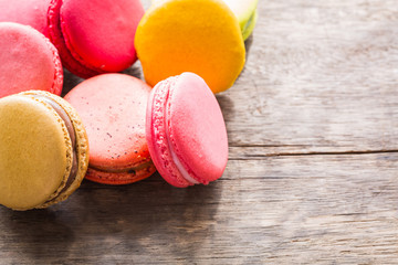 French colorful macarons on wood table