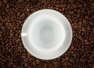 White ceramic cup on coffee background