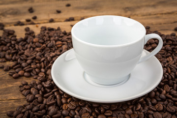 Coffee cup and coffee beans on a wooden table