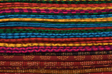 Obraz premium Heap of cloth fabrics at a local market in India.