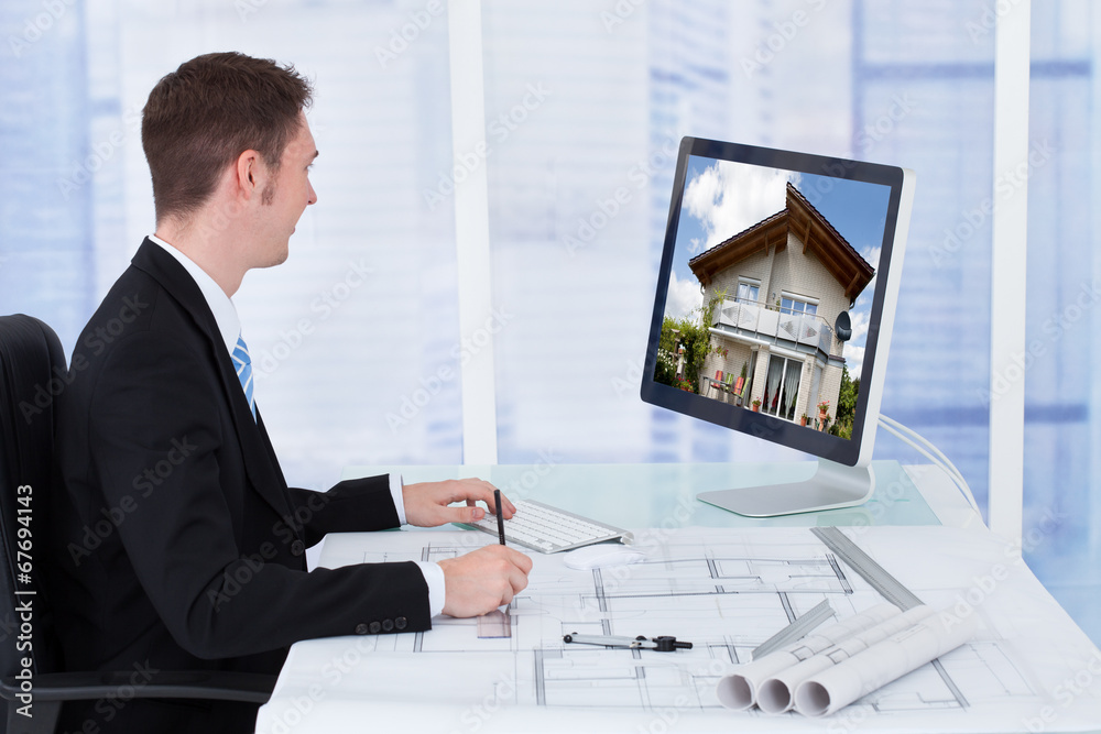 Poster Architect Working On Blueprint While Looking At Computer