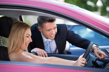 Salesman Showing Car To Customer