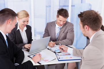 Business People Discussing At Table In Office