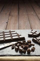 Pieces of chocolate on slate plate with copy space
