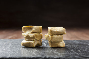 Two piles of caramels on slate plate