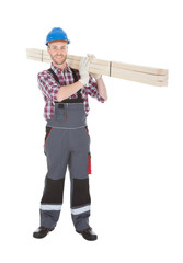 Manual Worker Carrying Wooden Planks