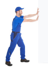 Confident Young Male Cleaner Holding Mop