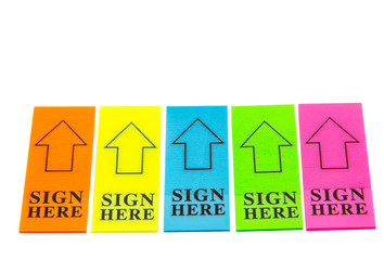 Colorful stick it SIGN HERE arrow tag over white background 