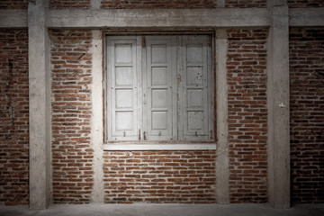 Obraz na płótnie Canvas Wooden window on brick wall
