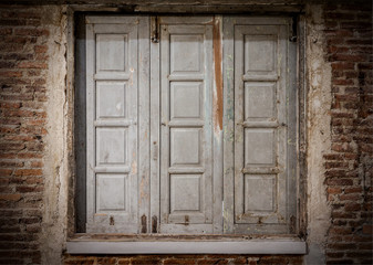 Wooden window on brick wall