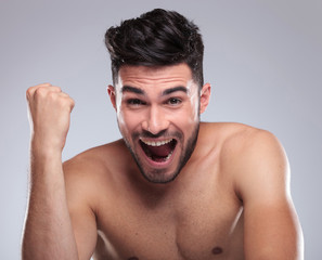 topless young man screaming of joy