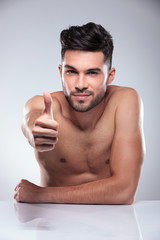 Fototapeta premium man sitting and making the ok sign