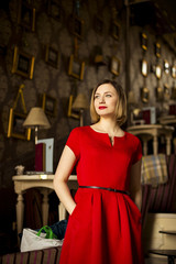 smiling girl in red dress  in cafe