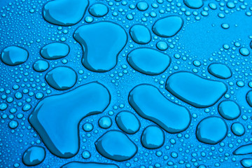 Water drops on a blue surface