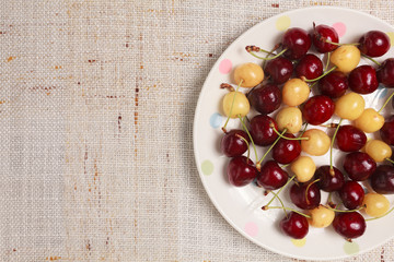 Fresh red and yellow cherries in a bowl