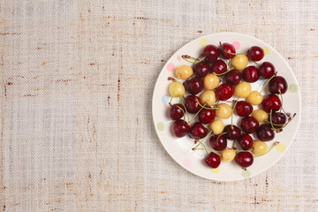 Fresh red and yellow cherries in a bowl
