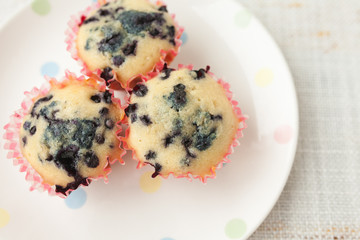 Homemade blueberry muffins in paper cupcake holder