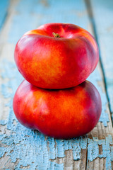 fresh organic flat nectarines on an old wooden background