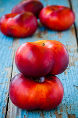 fresh organic flat nectarines on an old wooden background