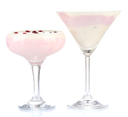 Glasses of yoghurt dessert with berries, isolated on white
