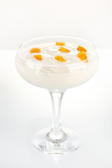 Glass of yoghurt dessert with fruits, isolated on white