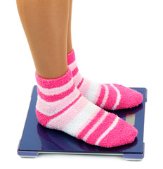 Feet on scales isolated on white