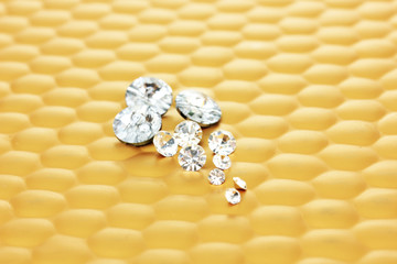Diamonds on bright yellow background, close-up