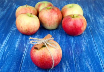 Ripe apples with with cinnamon sticks