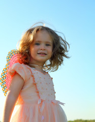 smiling little girl on meadow