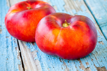 fresh organic flat nectarines on an old wooden background
