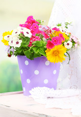 Bouquet of colorful flowers in decorative bucket,
