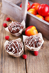 Tasty cupcakes with fruits on table close-up