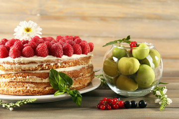 Tasty cake with fresh berries on wooden table