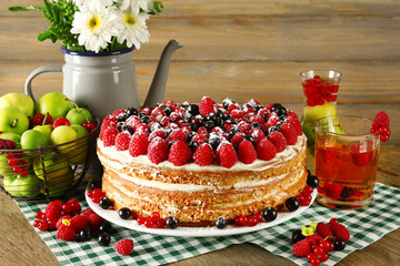 Tasty cake with fresh berries on table