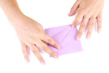 Hands making origami toy, close up, isolated on white