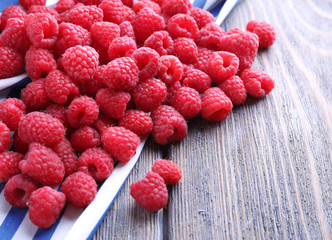 Ripe sweet raspberries on table close-up