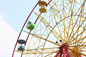Yellow ferris wheel on blue sky