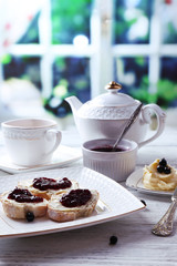 Fresh toasts with homemade butter and blackcurrant jam