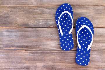 Color flip-flops on wooden background