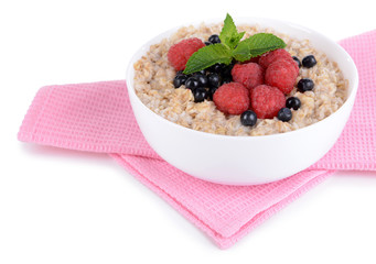 Tasty oatmeal with berries isolated on white