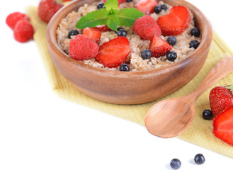Tasty oatmeal with berries isolated on white