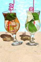 Delicious cocktails on beach, close-up