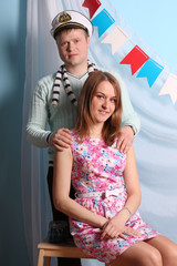 Beautiful smiling woman and man pose in studio