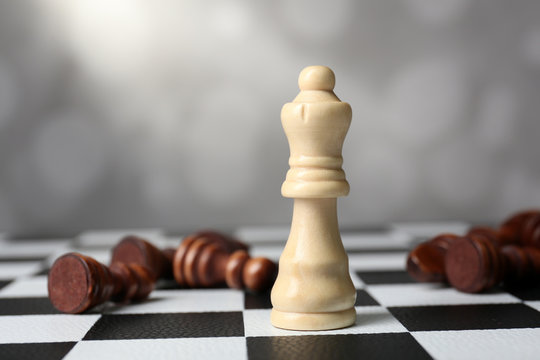 Chess board with chess pieces on grey background