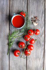 Homemade tomato juice in color mug, spices and fresh tomatoes