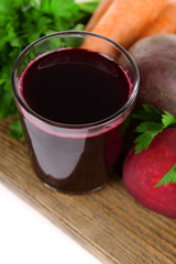 Glass of fresh beet juice and vegetables
